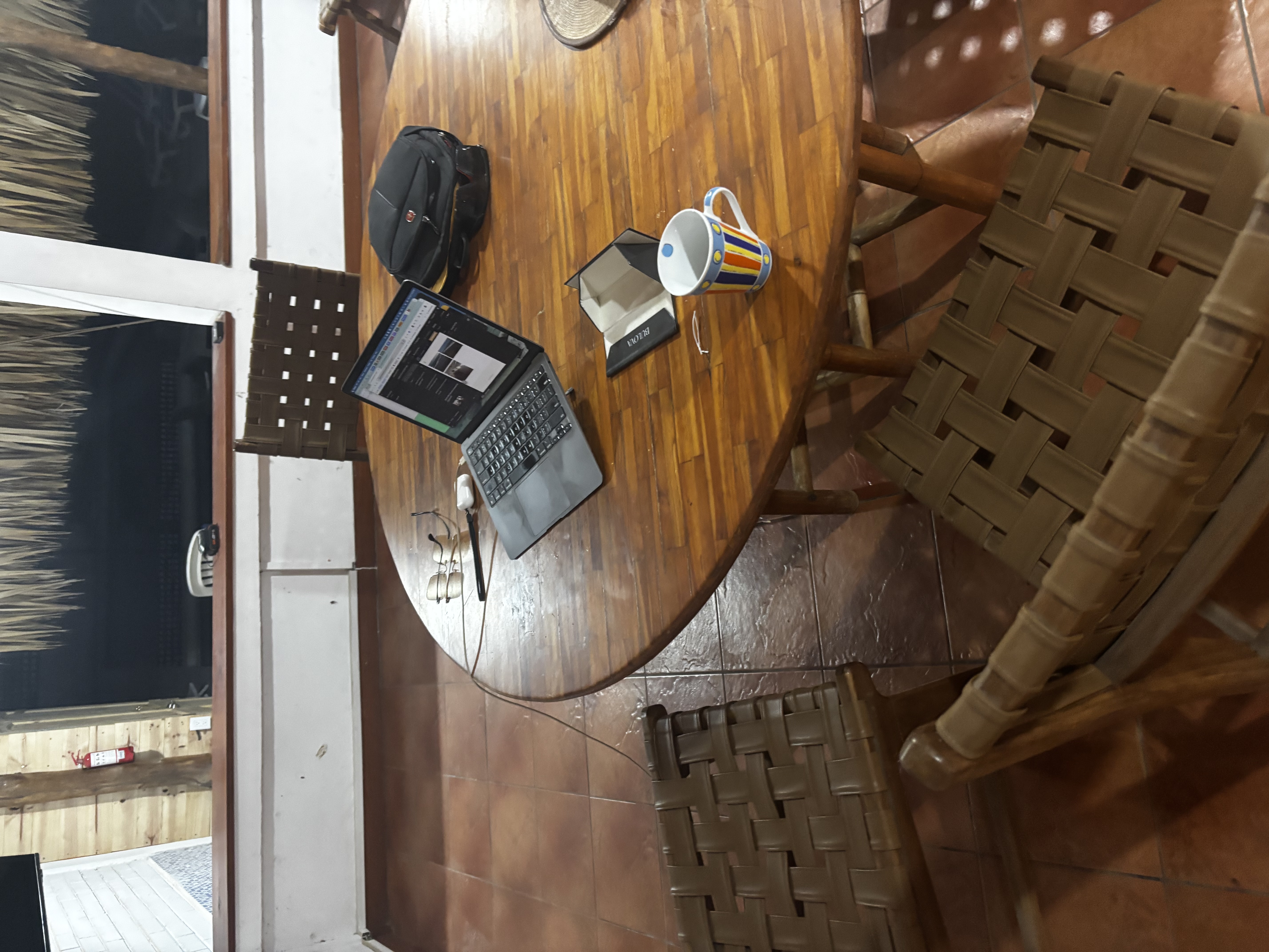 Remote Work Setup with Laptop and Coffee at Round Dining Table – Work from Paradise at Oceanfrontsunsetvilla, La Libertad El Salvador